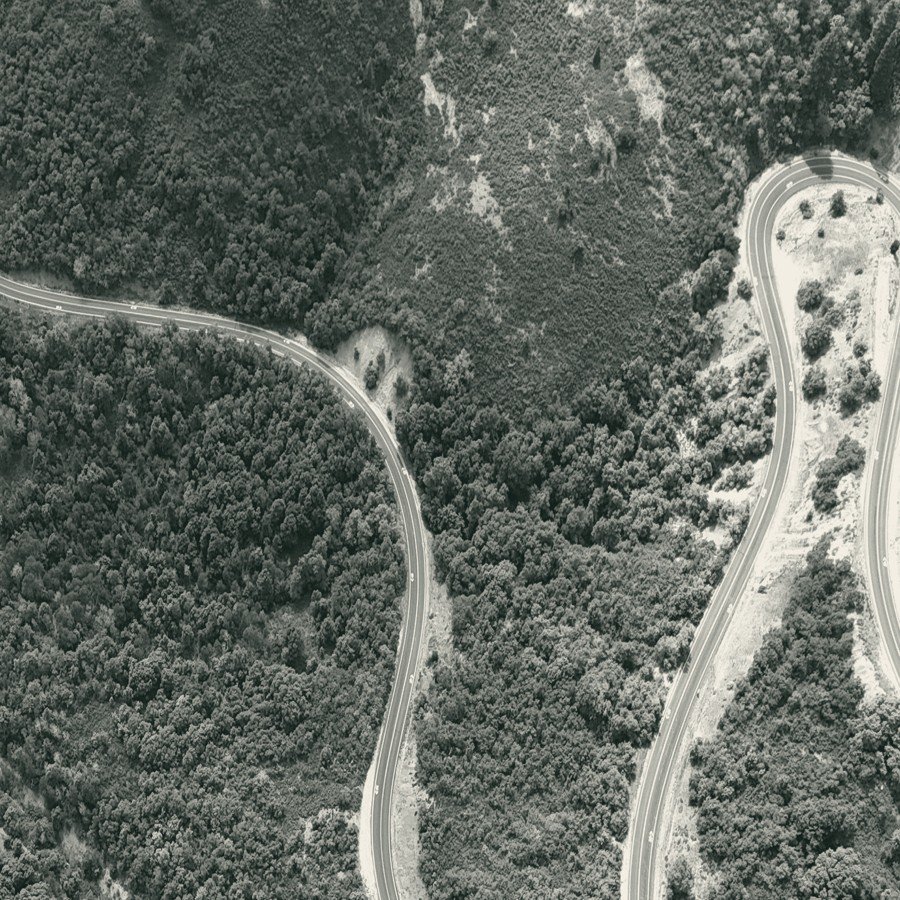 Aerial view of a winding road through forest
